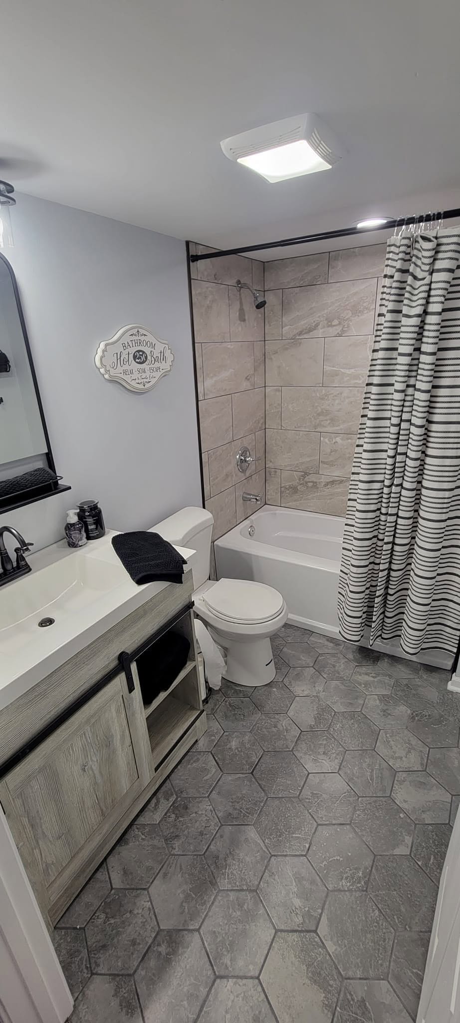 Stone-Look Tile Tub Surround & Rustic Sliding Barn Door Vanity