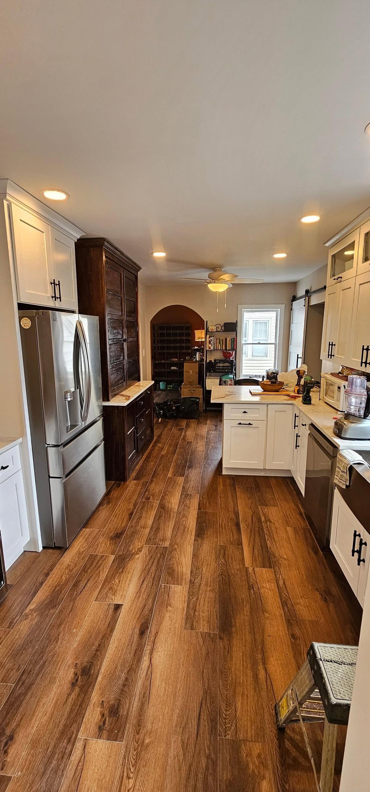 Galley Kitchen with Rich Wood Plank Flooring